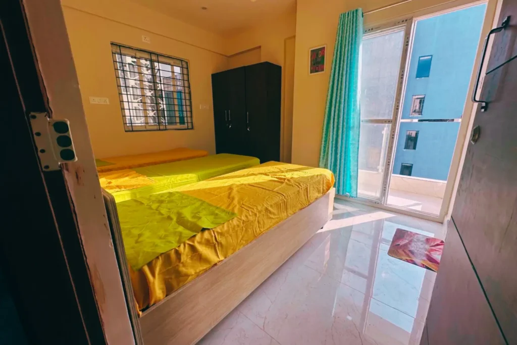 Affordable triple occupancy PG room in Bangalore colive space with beds wardrobes and study desks - best colive pg in kundalahalli