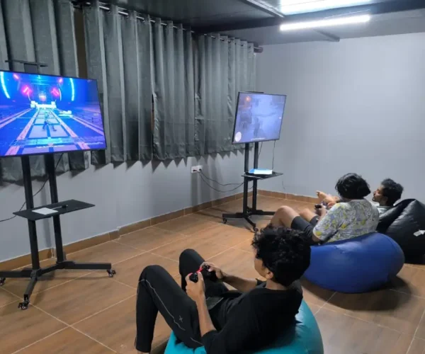 Gaming lounge with TV and bean bags at Co Living PG in Bangalore.